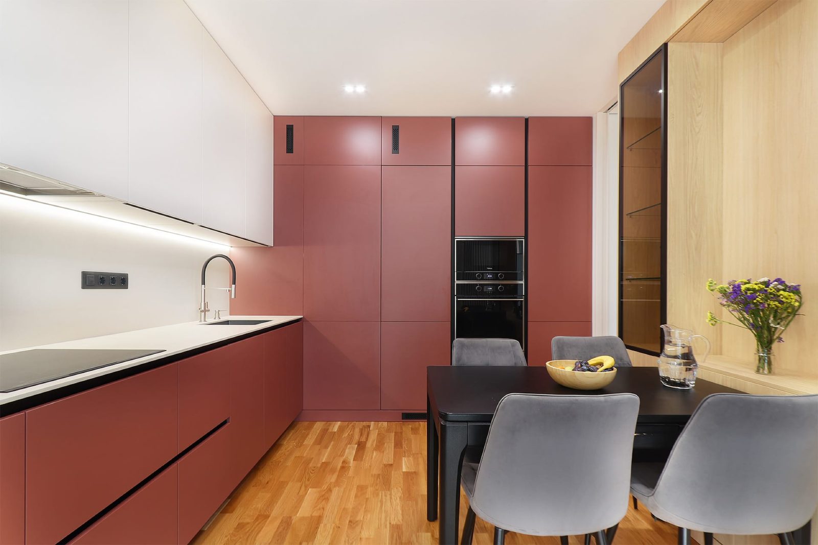 Kitchen run with hob and tall red cabinets