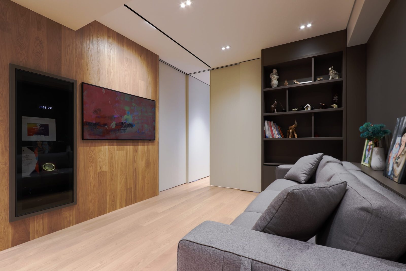Oak-clad wall with TV and artwork behind the sofa
