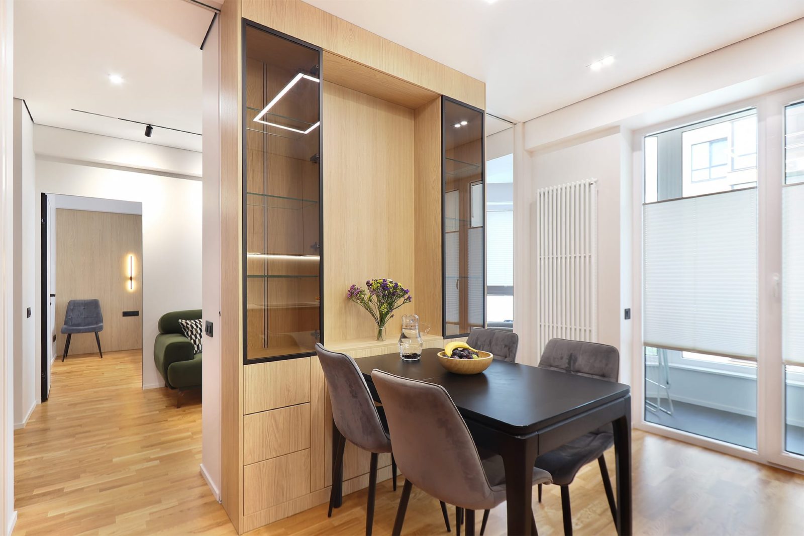 Dining table by the window with glass display cabinet