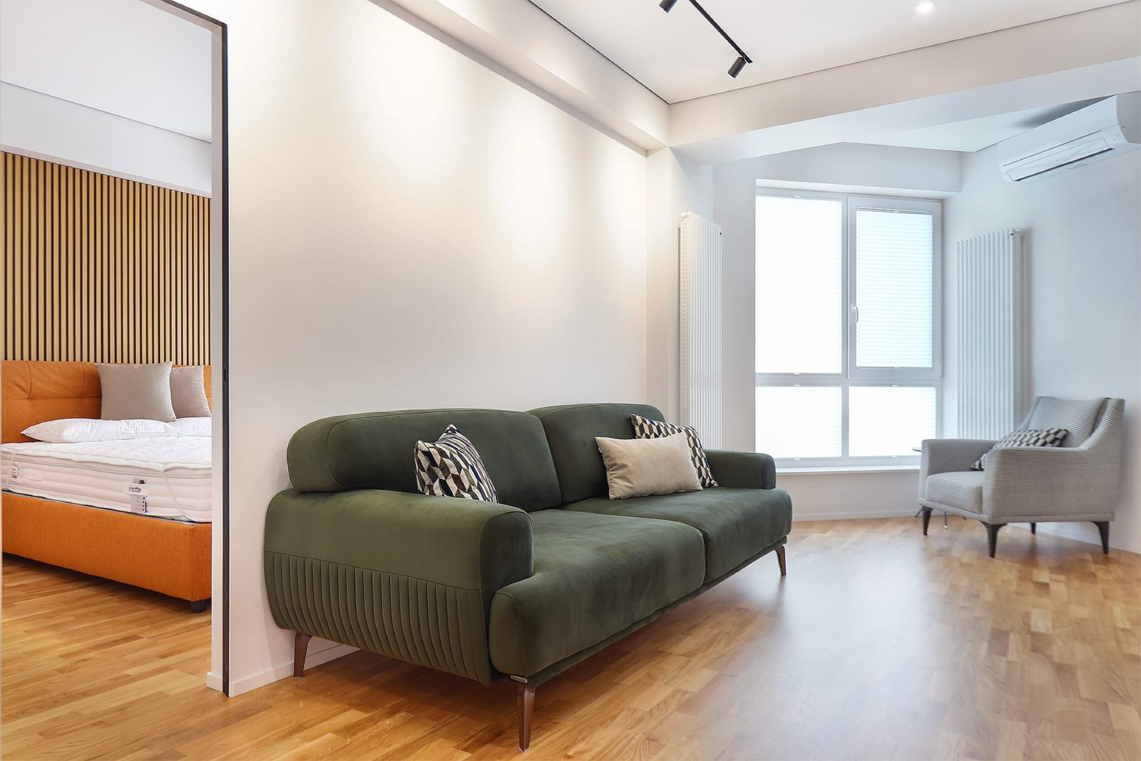 Living room with green sofa and armchair