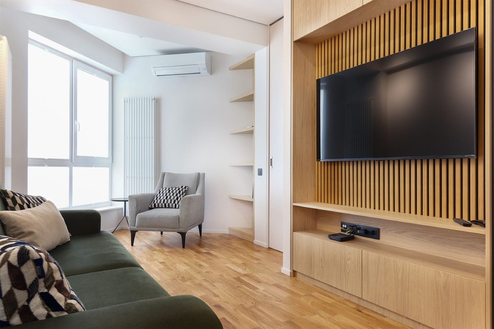 Living room corner with slatted TV wall