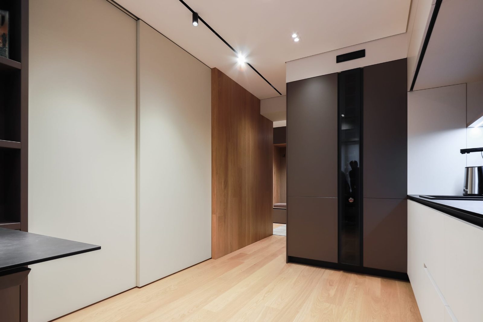 Open-plan space with the cream sliding panel across the kitchen
