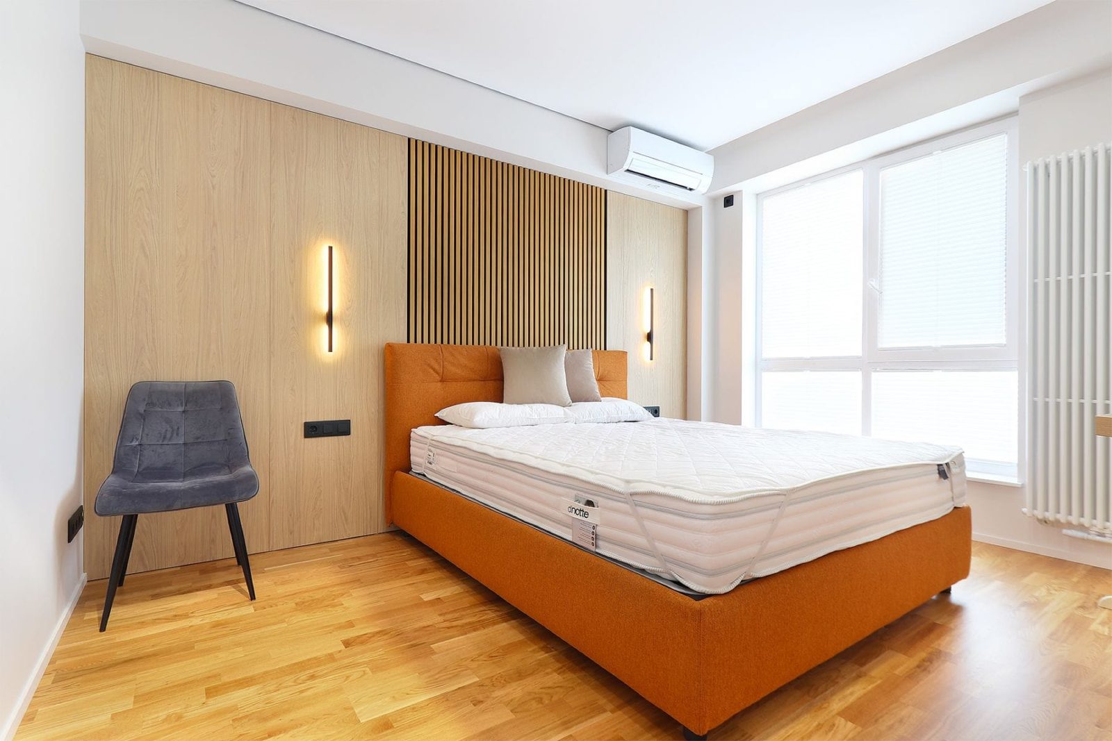 Bedroom with orange bed and slatted wall