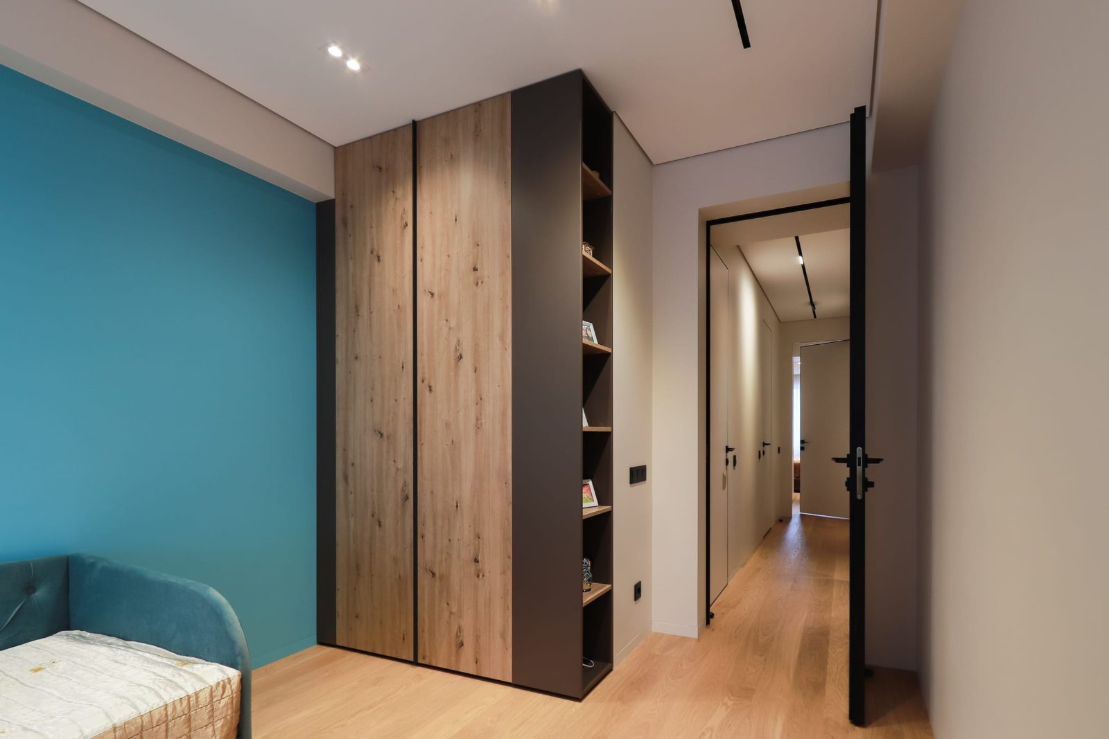 Teal wall and wardrobe, with the hallway beyond